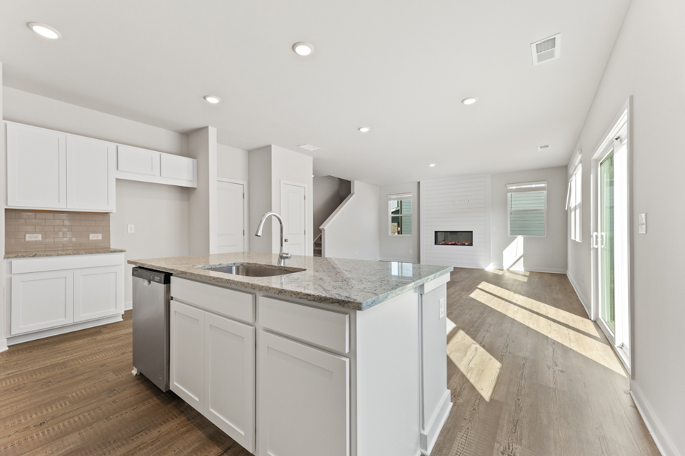 A kitchen with white cabinets.
