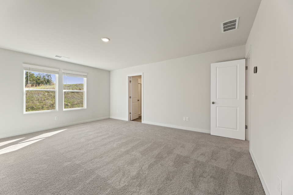 A room with white walls and a door.