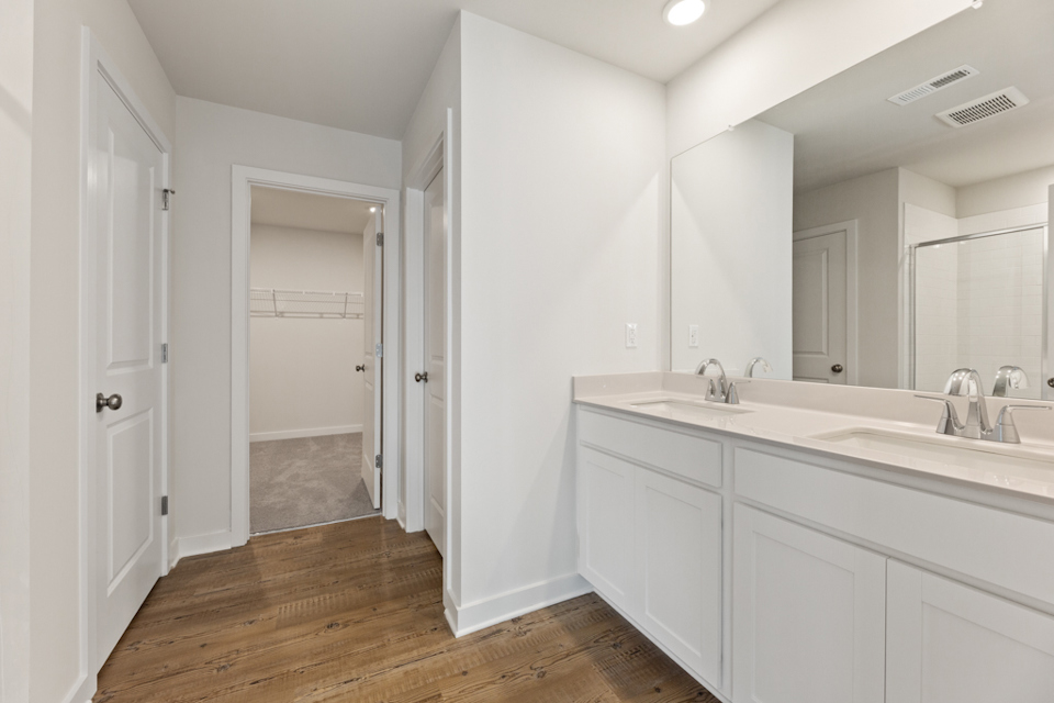 A bathroom with white cabinets.