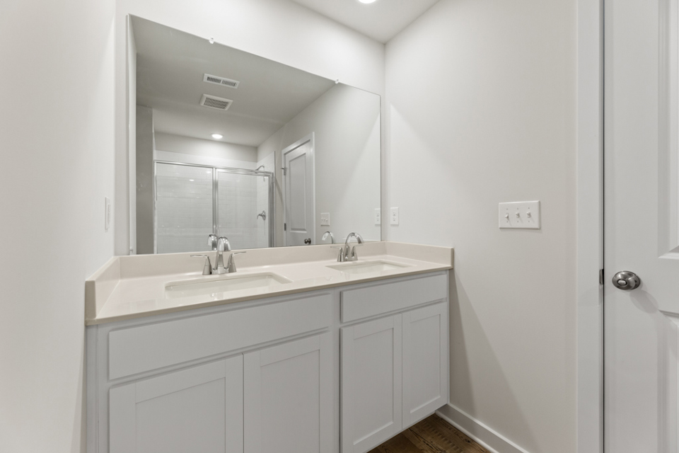 A bathroom with a large mirror.