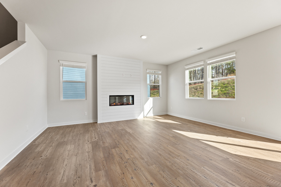 A room with a fireplace and a wood floor.
