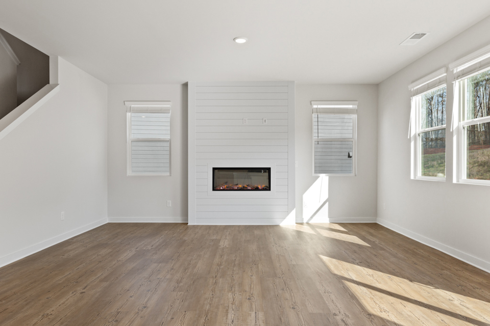 A room with a fireplace and windows.