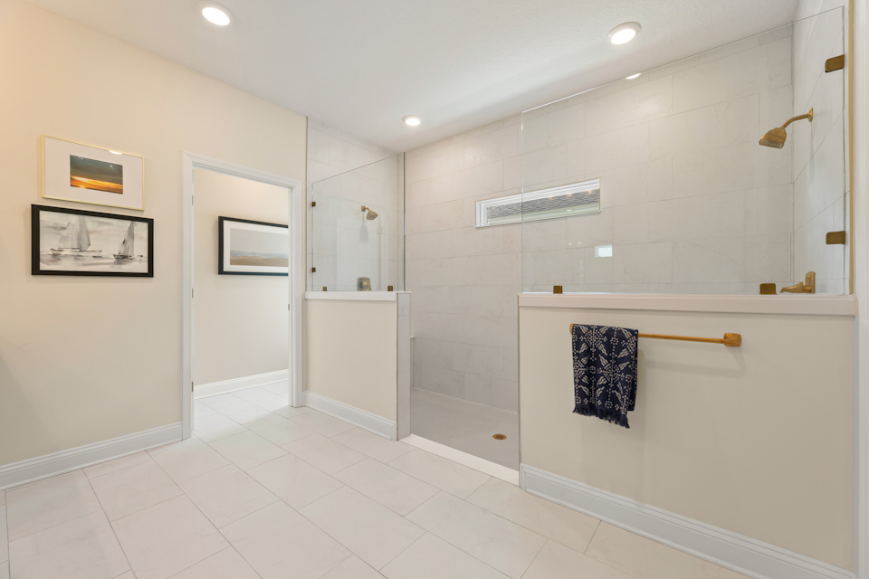 A bathroom with white tile.