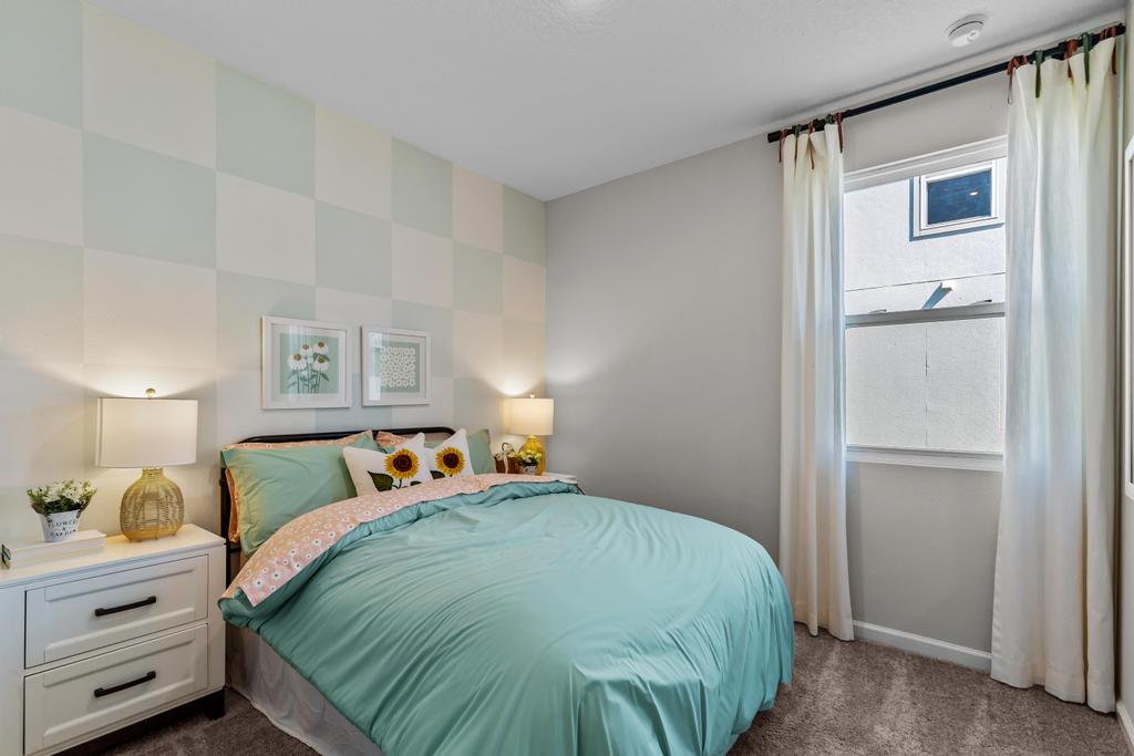 A bedroom with a bed and a window.