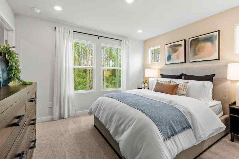 A bedroom with a bed and a window.