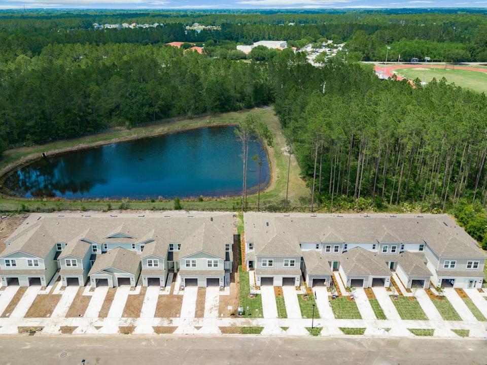 A large pool of water surrounded by trees and buildings.