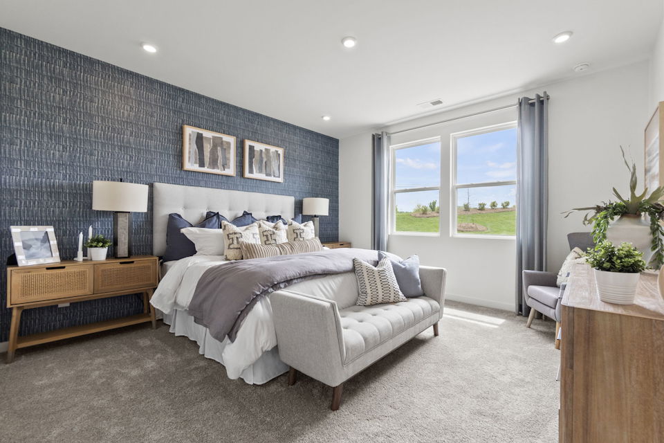 A bedroom with a large bed and a couch.