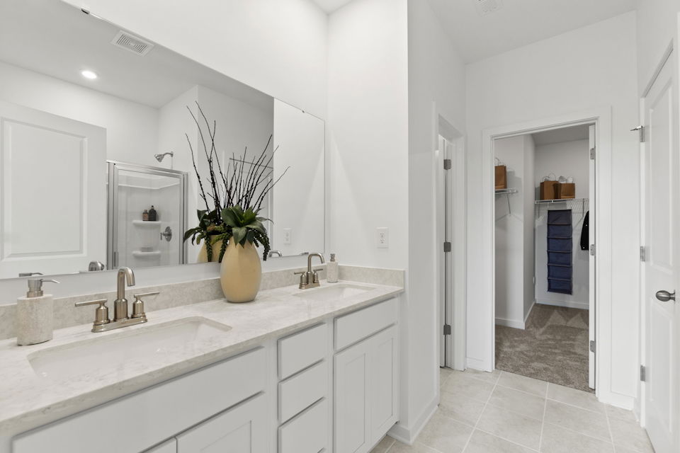 A bathroom with a sink and a mirror.