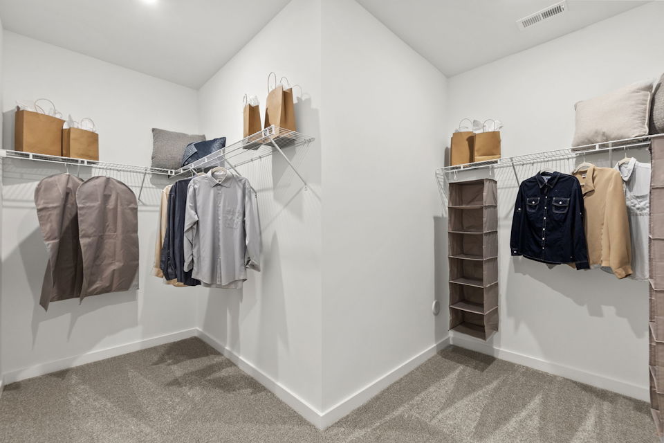 A room with a white wall and a white wall with a white wall with a black and brown.