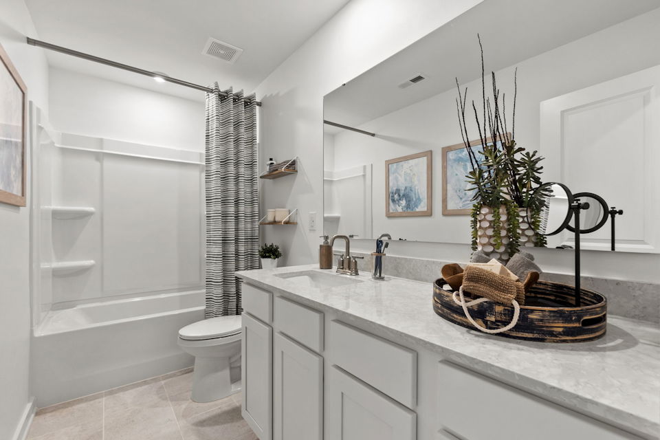 A bathroom with a tub sink and a toilet.