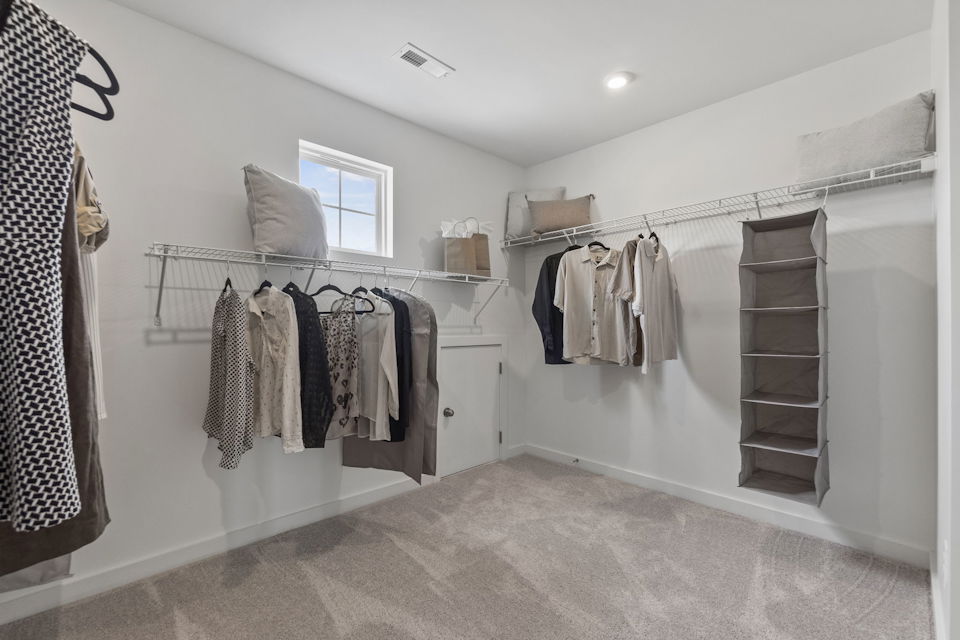 A room with a wall of clothes.