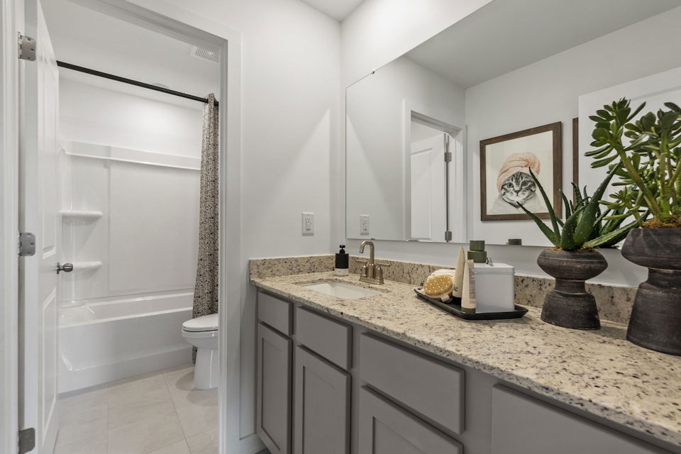 A bathroom with a marble countertop.
