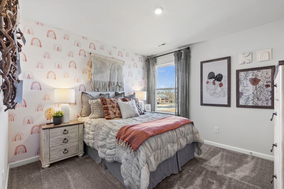 A bedroom with a bed and a window.