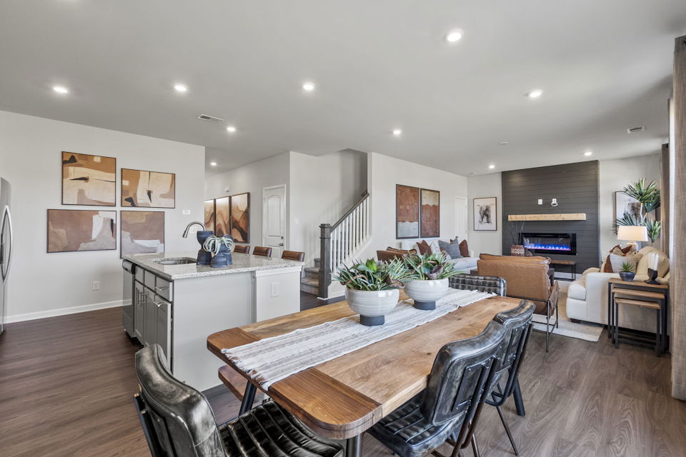 A large kitchen with a dining table.