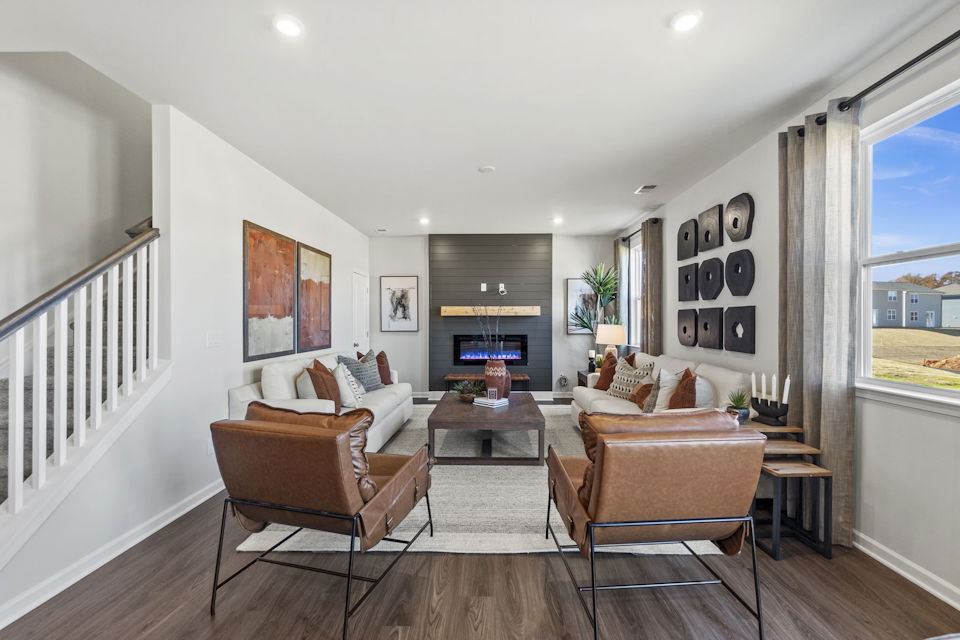 A living room with a large staircase.