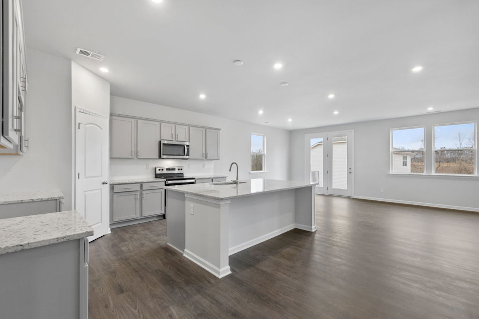 A kitchen with white cabinets.