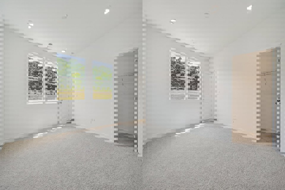 A room with white walls and a window.