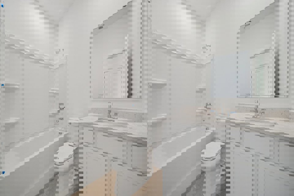 A bathroom with a toilet and sink.