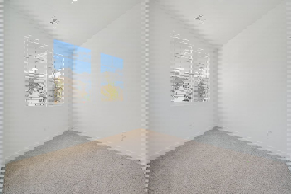A room with a window and a carpet.