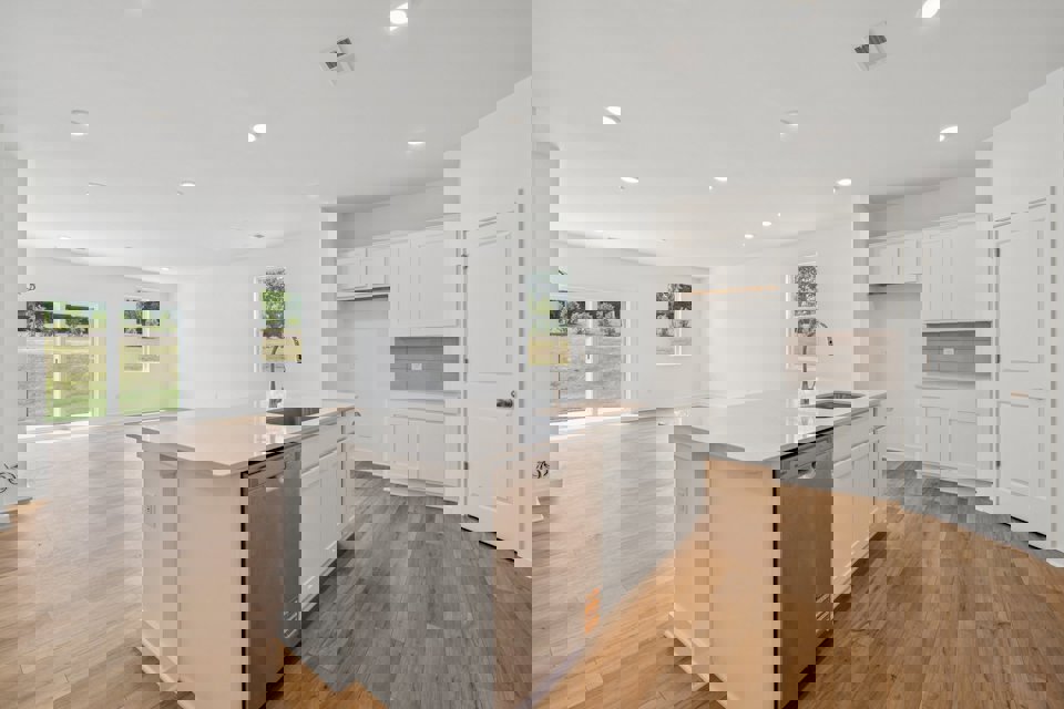 A kitchen with white cabinets.