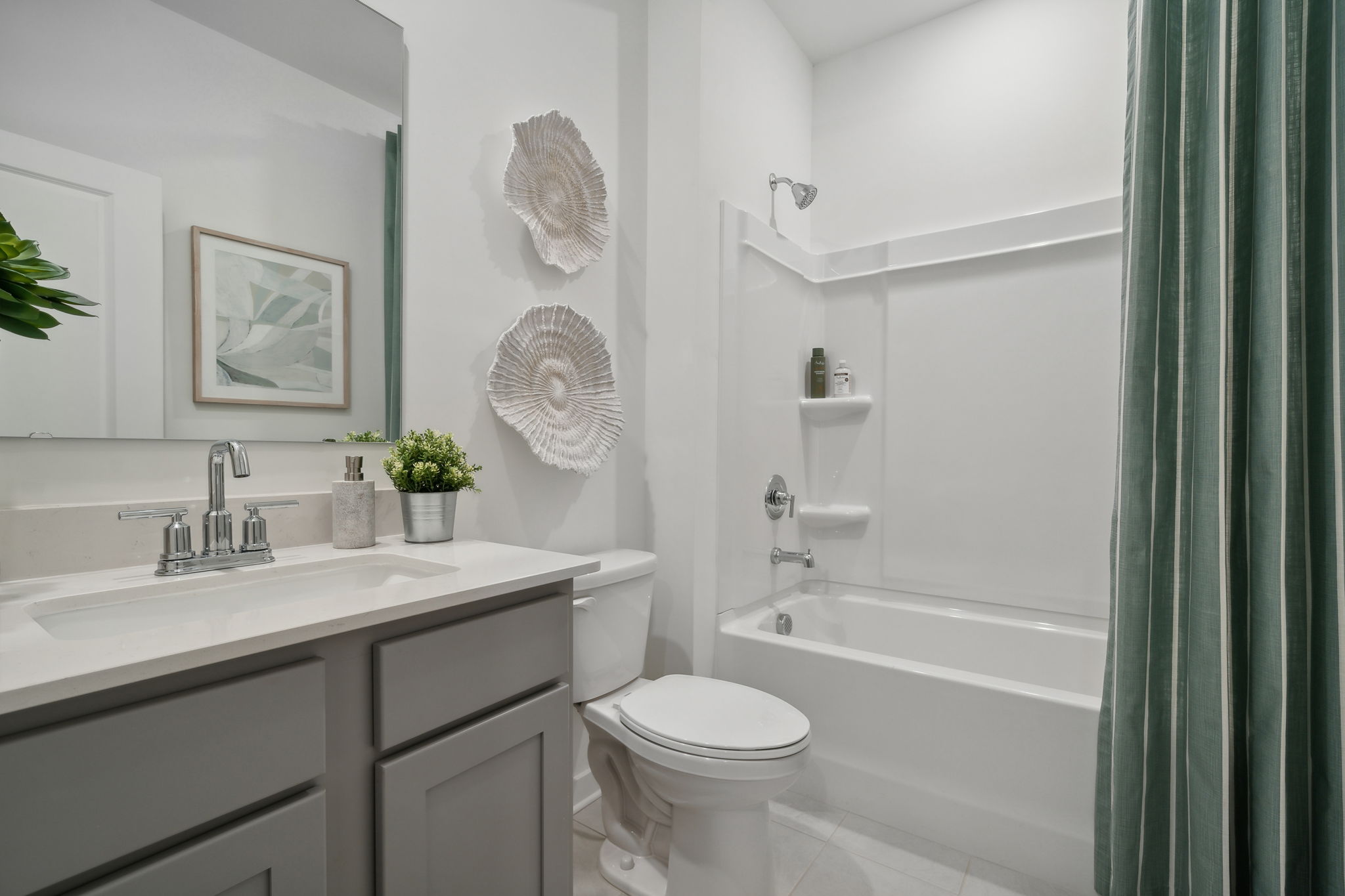 A bathroom with a tub toilet and sink.