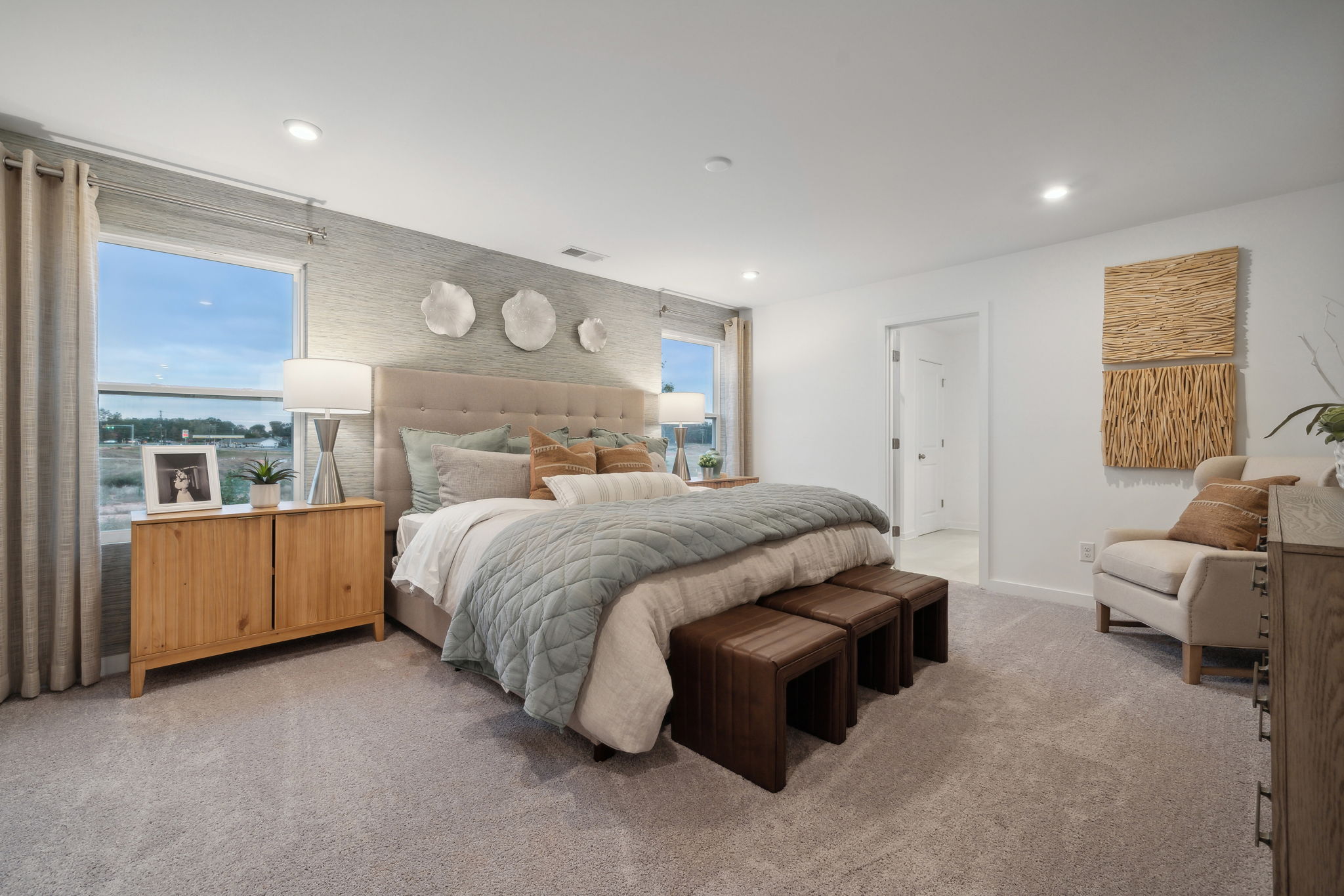 A bedroom with a large window.