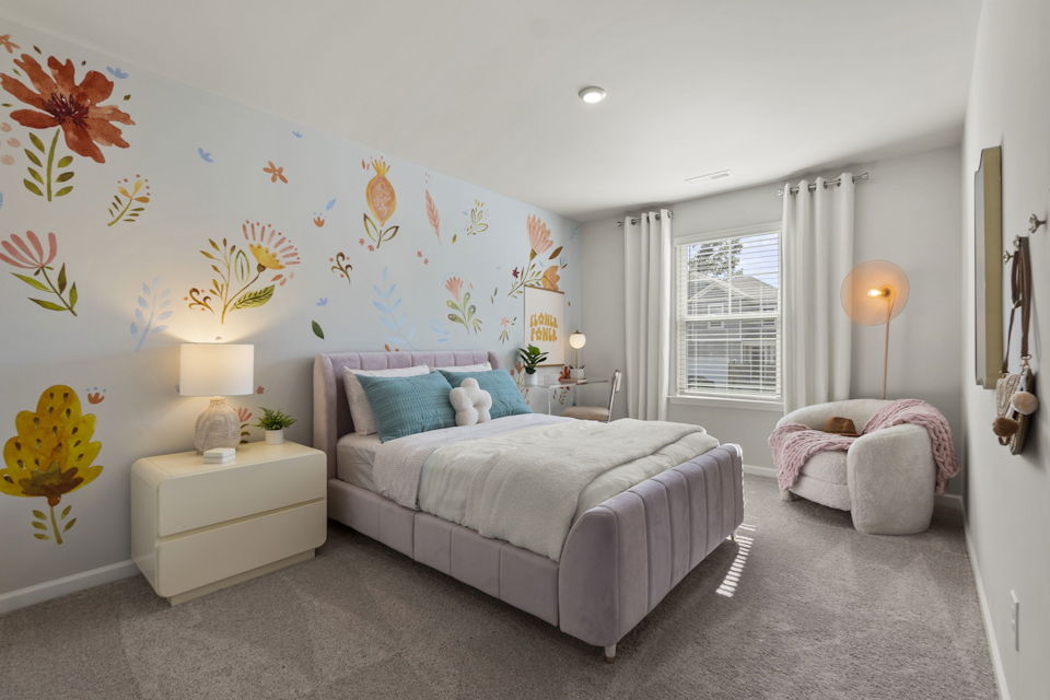 A bedroom with a bed and a couch.