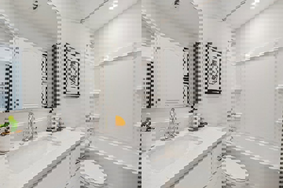 A bathroom with a tub sink and toilet.
