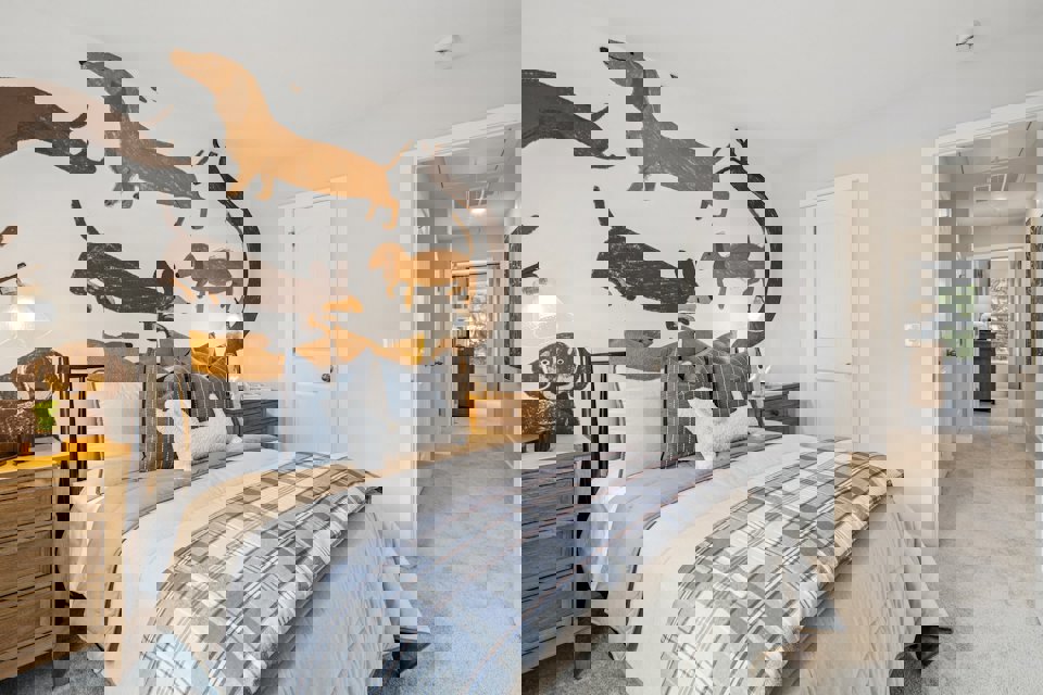 A bedroom with a bed and a wall with fish on it.