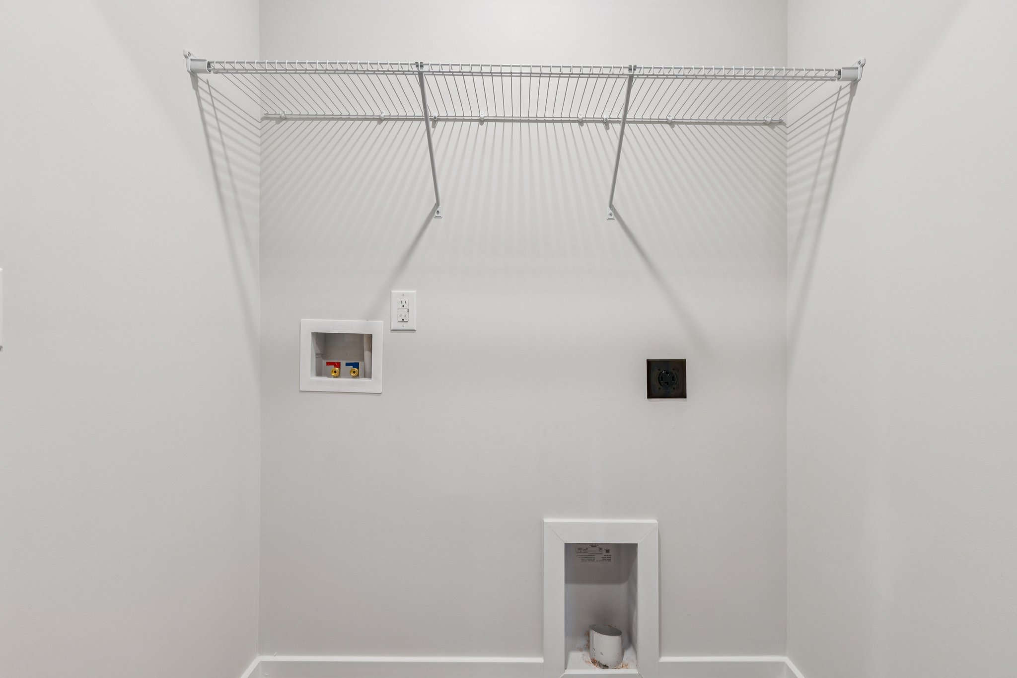 A white wall with a vent.