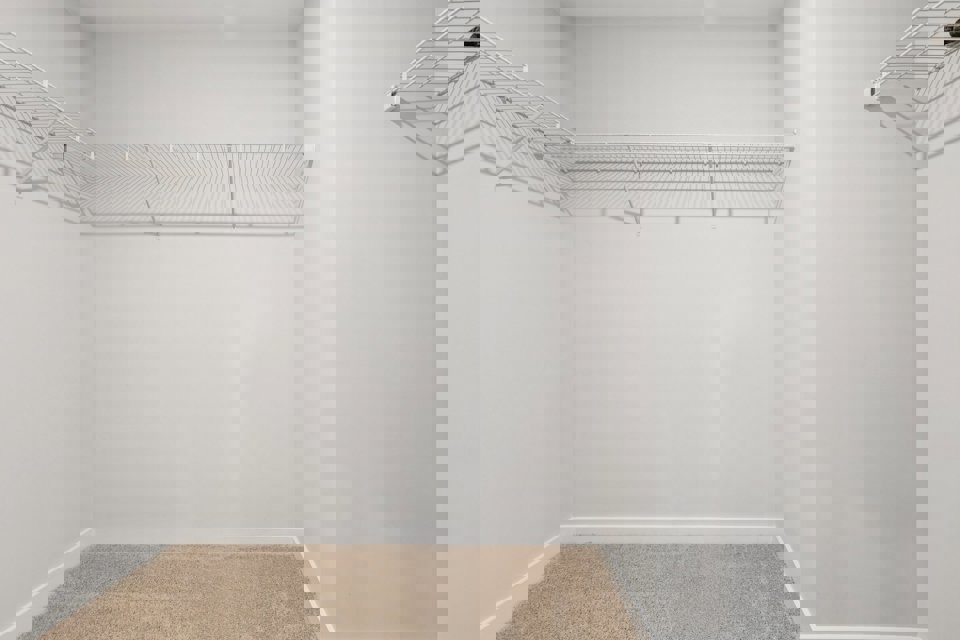 A white room with a rug.