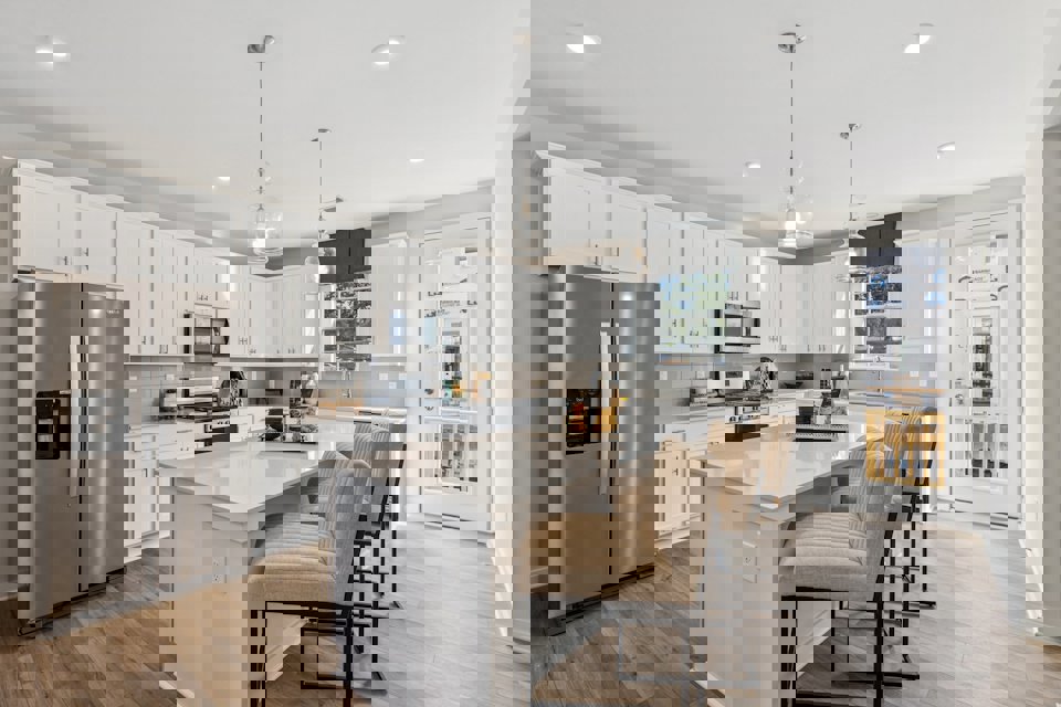 A kitchen with white cabinets.