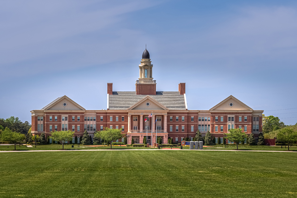 A large building with a lawn in front of it.