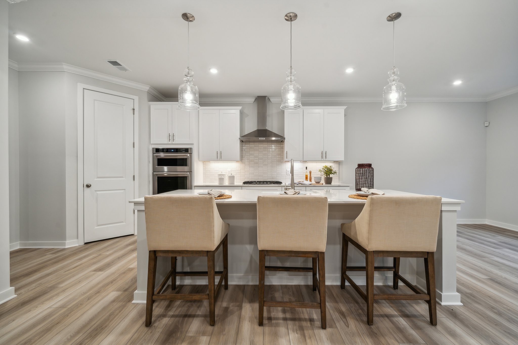 A kitchen with a table and chairs.