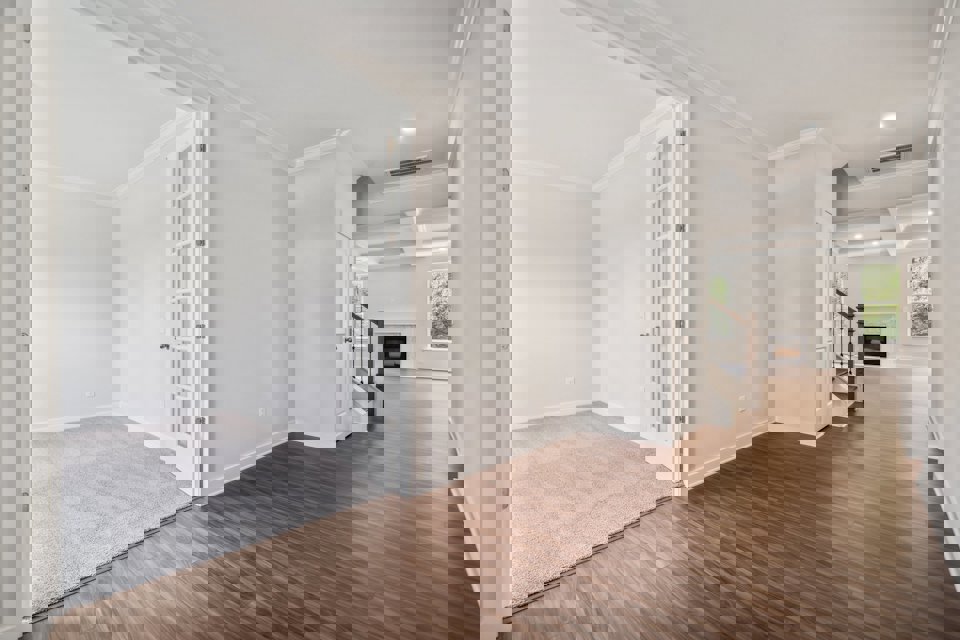 A room with a wood floor and white walls.