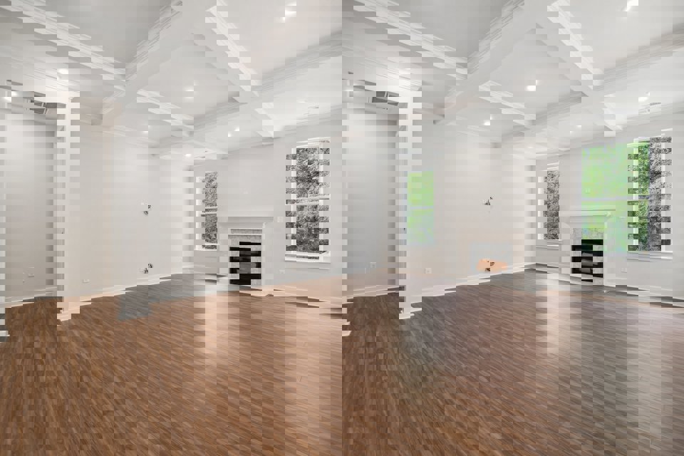 A large empty room with a fireplace.