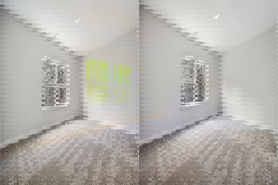 A room with a window and carpet.