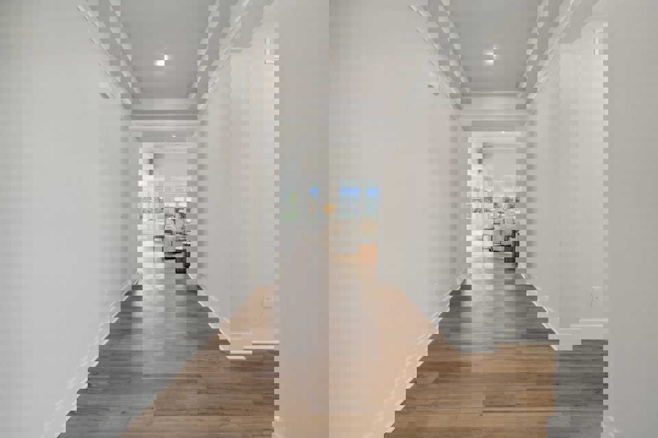 A long hallway with white walls.