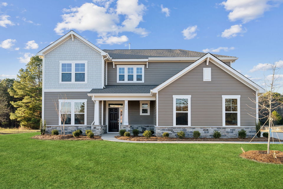 A house with a lawn in front.