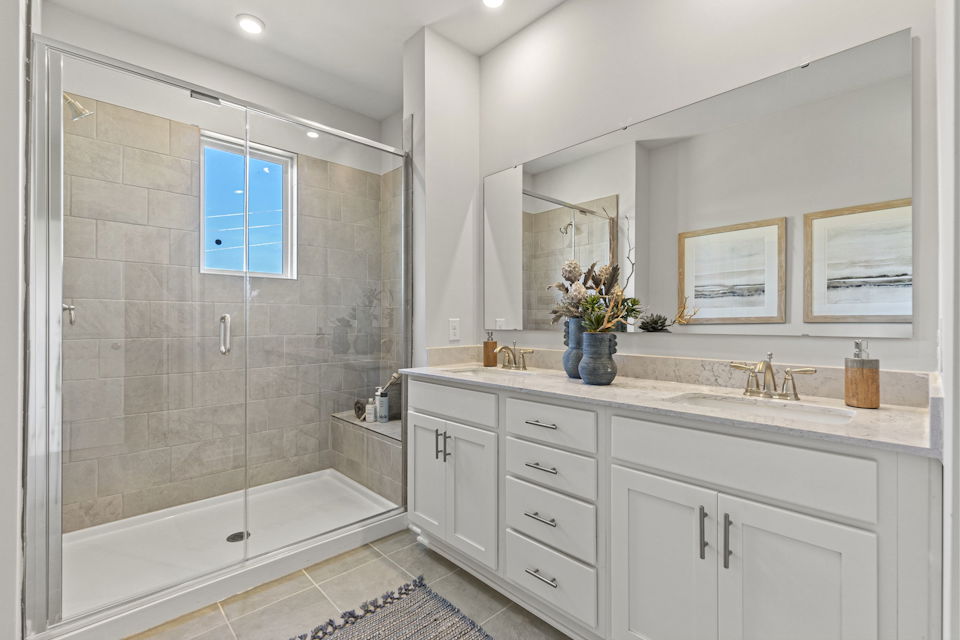 A bathroom with a shower and sink.