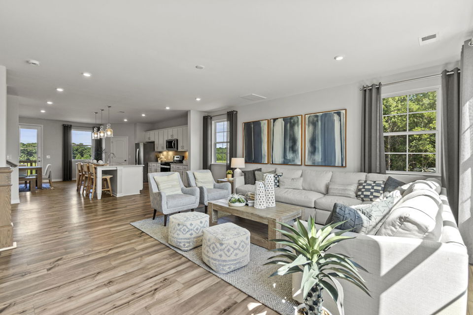 A large living room with a wood floor.