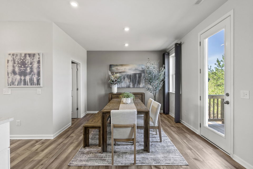 A dining room with a wood floor.