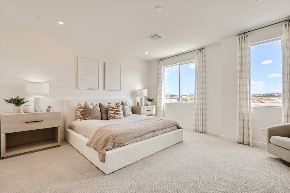 A bedroom with a large window.