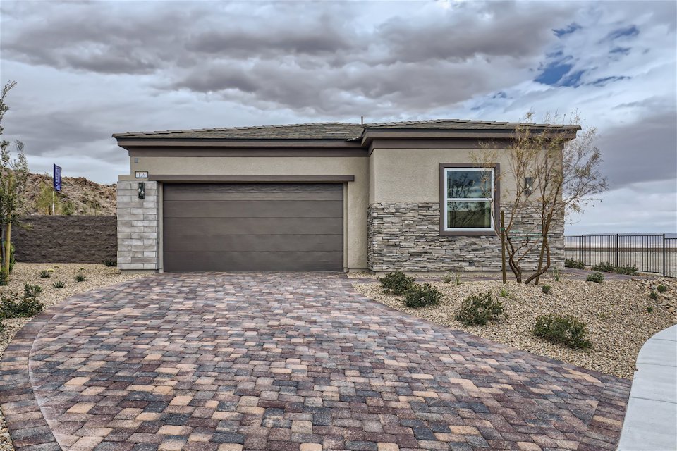 A house with a brick driveway.