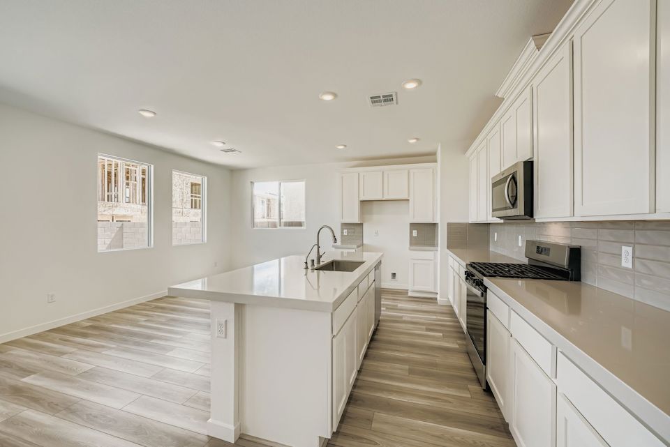A kitchen with white cabinets.