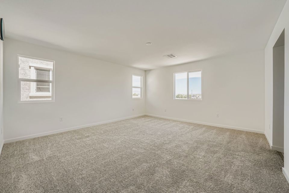 A room with a carpet and windows.