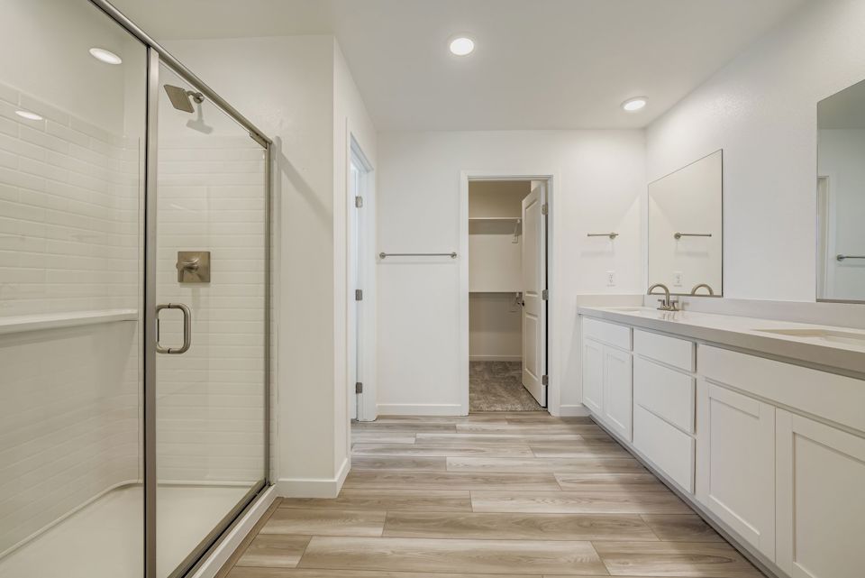 A bathroom with white cabinets.