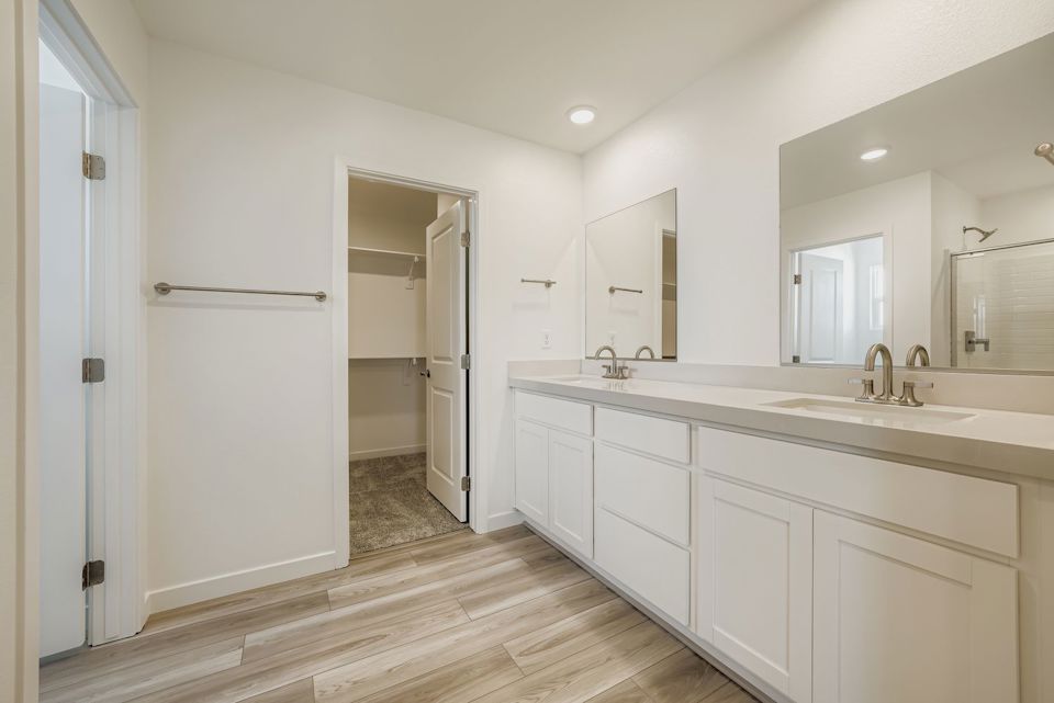 A bathroom with white cabinets.