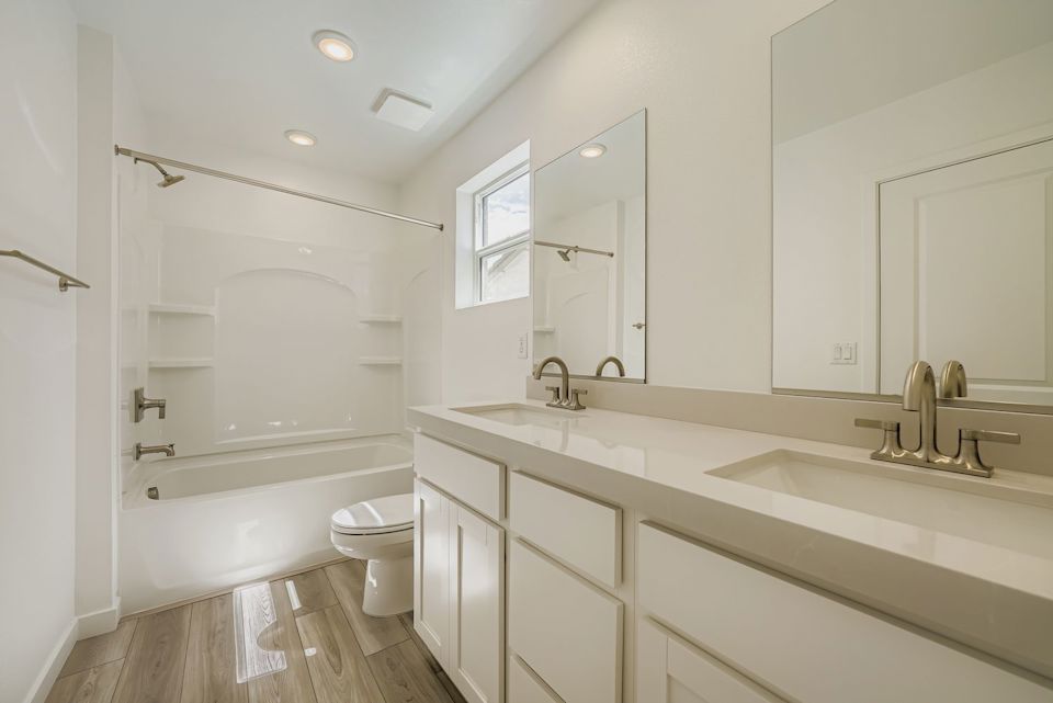 A bathroom with a tub sink and toilet.