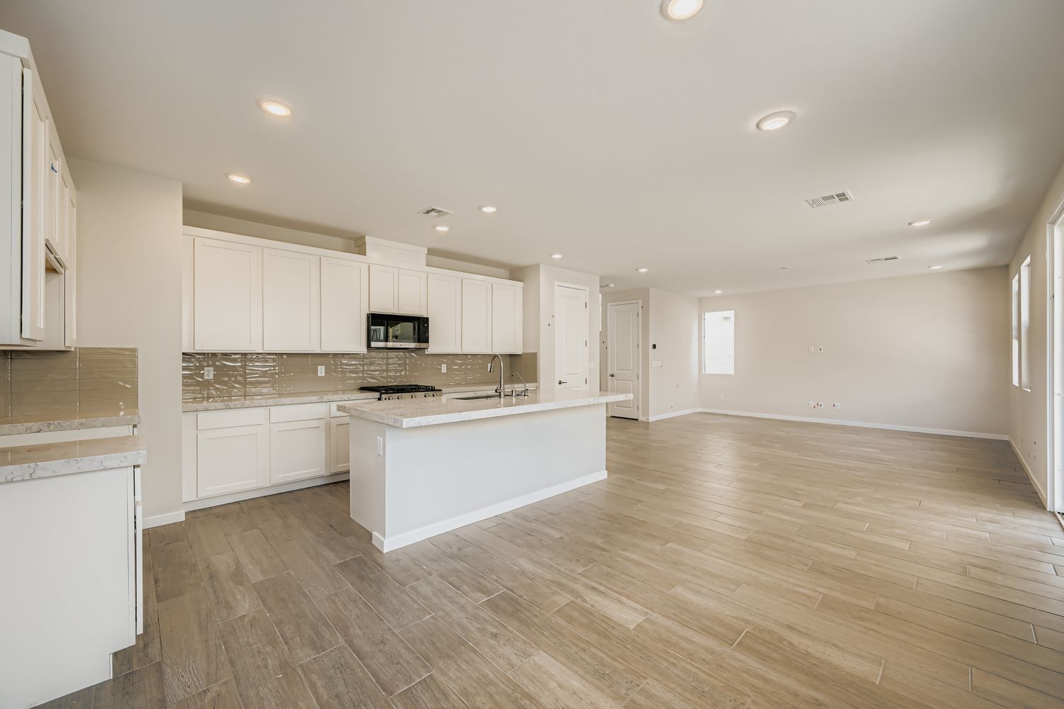 A large kitchen with white cabinets.